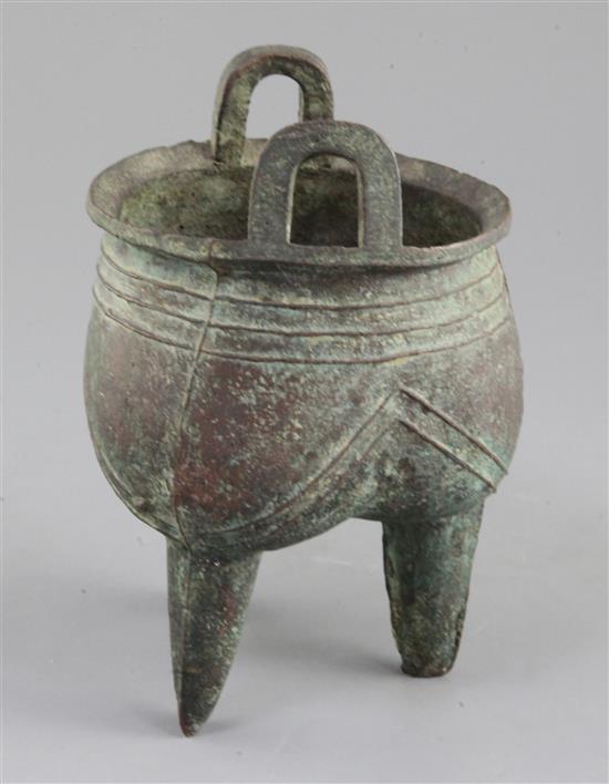 A Chinese archaic bronze tripod ritual vessel, Liding, 12th-11th century B.C., 17.5cm high